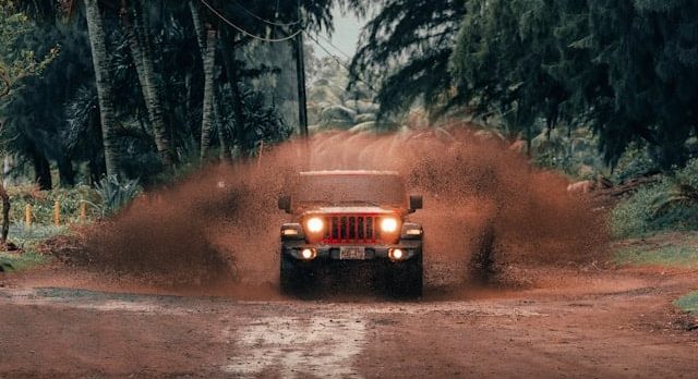 a truck driving down a dirt road
