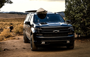 a car parked on the side of a dirt road