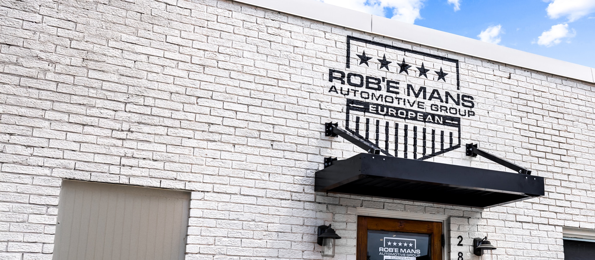 a sign in front of a brick building