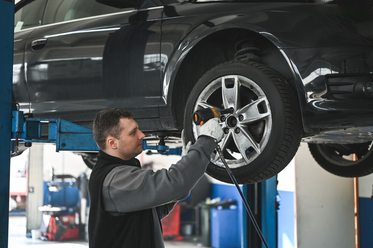 a man standing in front of a car