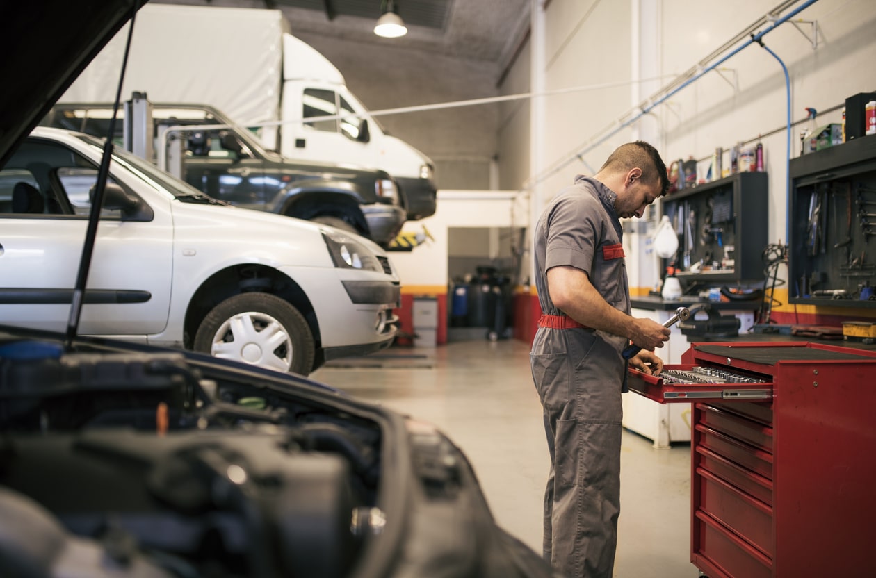 a man standing next to a car