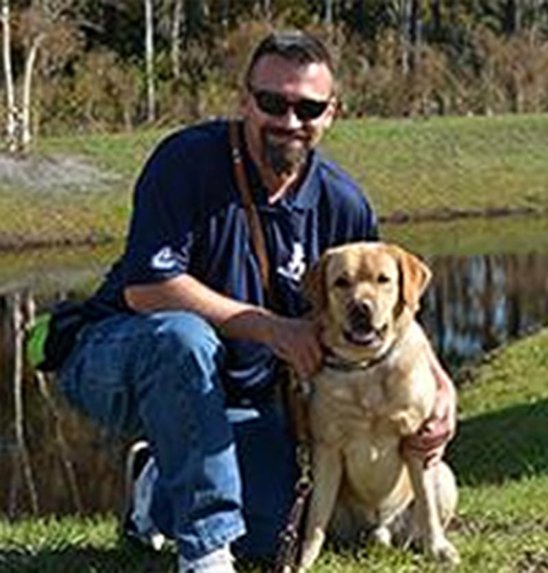 a man and a dog posing for the camera